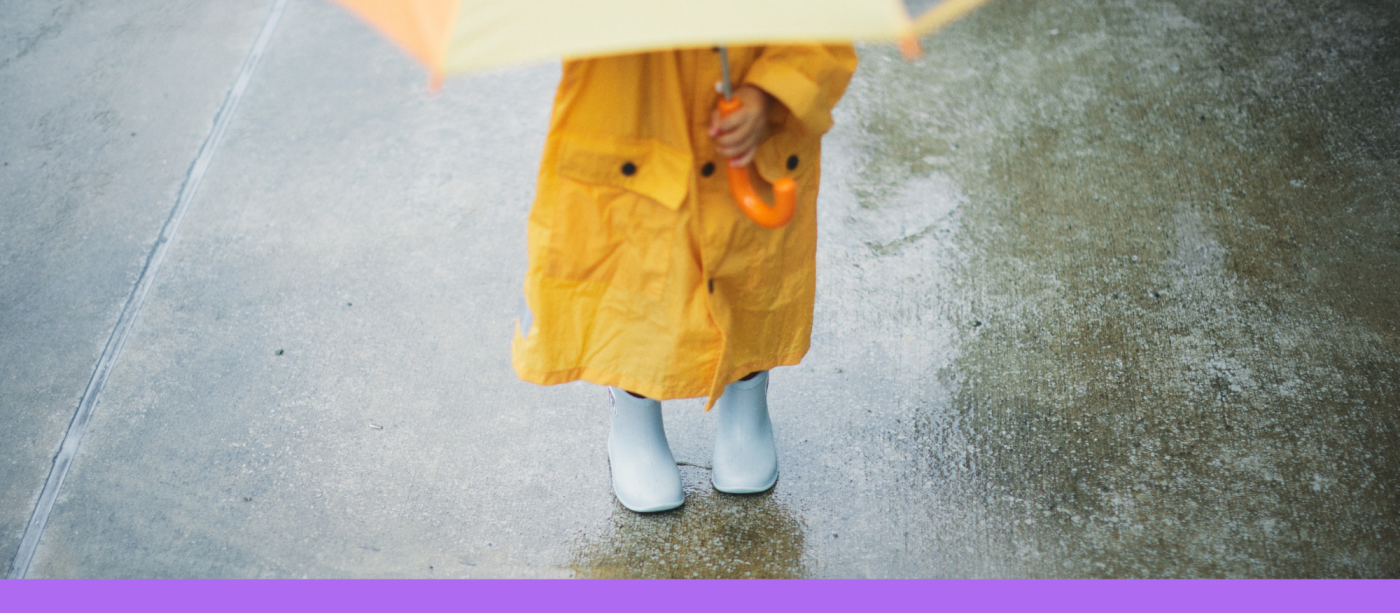 Child holding an umbrella on a rainy day