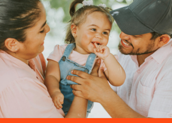 mother and father holding young daughter